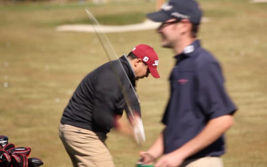 John F. warms up with a few iron shots.